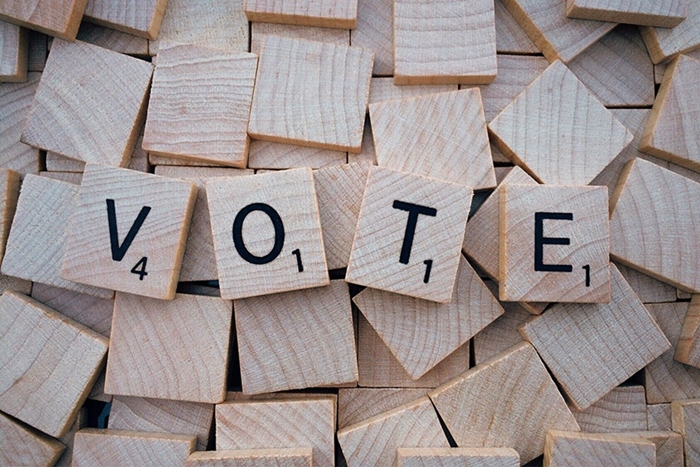 Illustration of scrabble letters saying VOTE