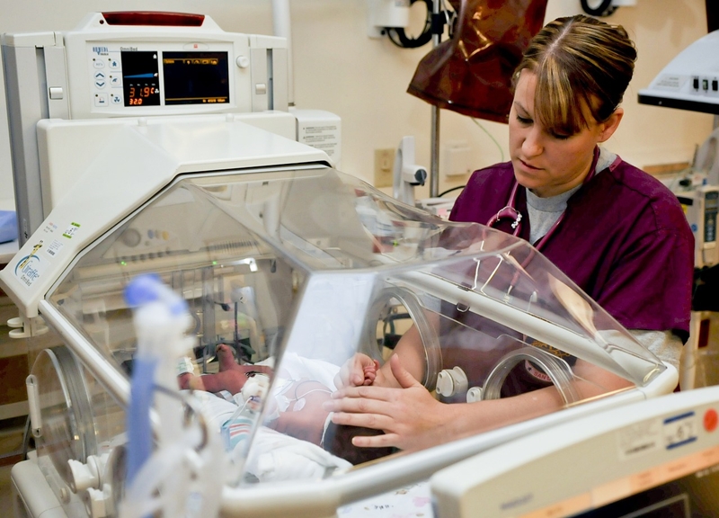 Photo of nurse with baby in maternity ward