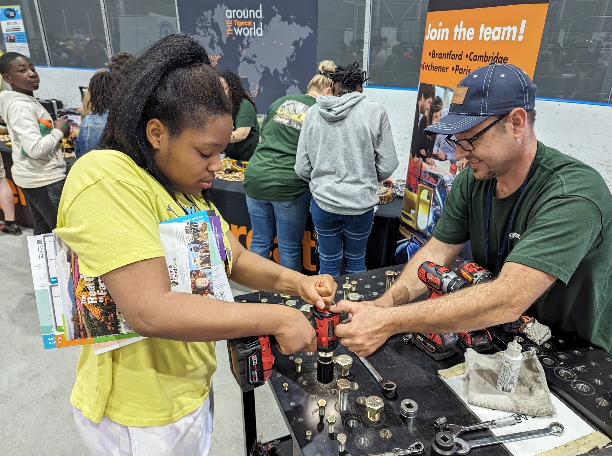 Photo of student using power tool at Tigercat Industries booth - Epic Jobs 2024